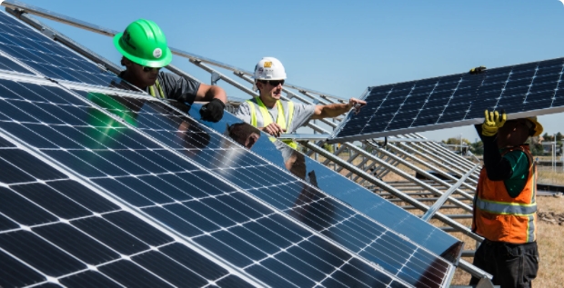 Contractors installation a solar panel array.